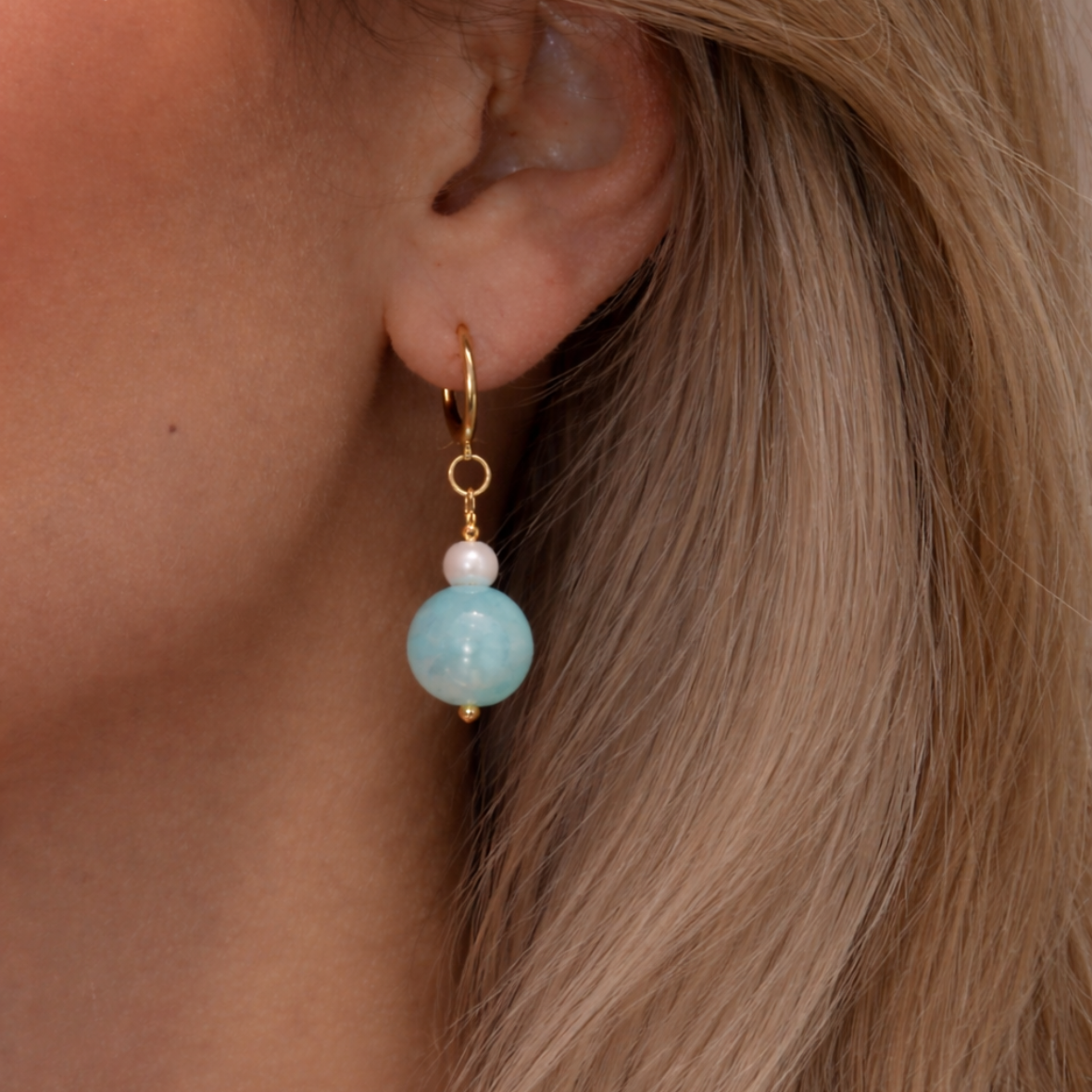 Blue gemstone drop earrings with freshwater pearl accents on gold huggie hoops