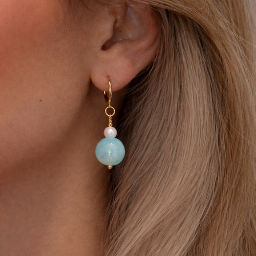 Blue gemstone drop earrings with freshwater pearl accents on gold huggie hoops