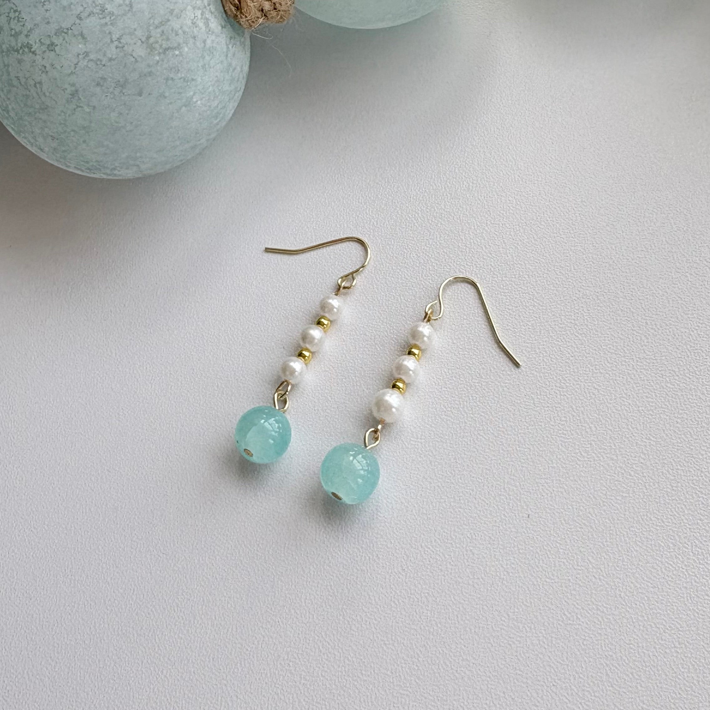 Coastal blue pearl drop earrings with gold huggie hoops and freshwater pearl accents